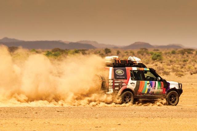 loaded and on the road to another adventure the land rover spills a captivating trail of dust