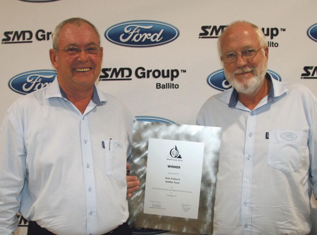 dealer principle ivan hartley presents smd groups ford service manager rob pollock with his outstanding service management award