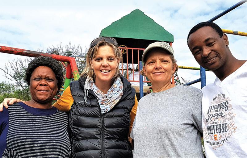 seen in a break from wielding a paintbrush with mrs angela nhlangulela owner of siyakhula creche tarin stevenson door relations manager at the domino foundation brenda scheepers and mpilo vilakazi